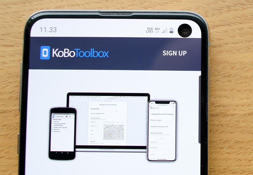 Mobile phone with KoBoToolbox website.