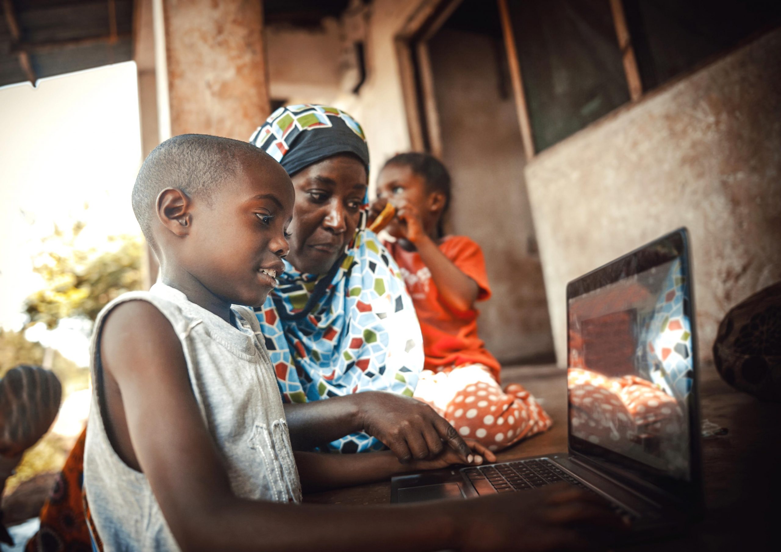 Photo of an African family on a laptop.