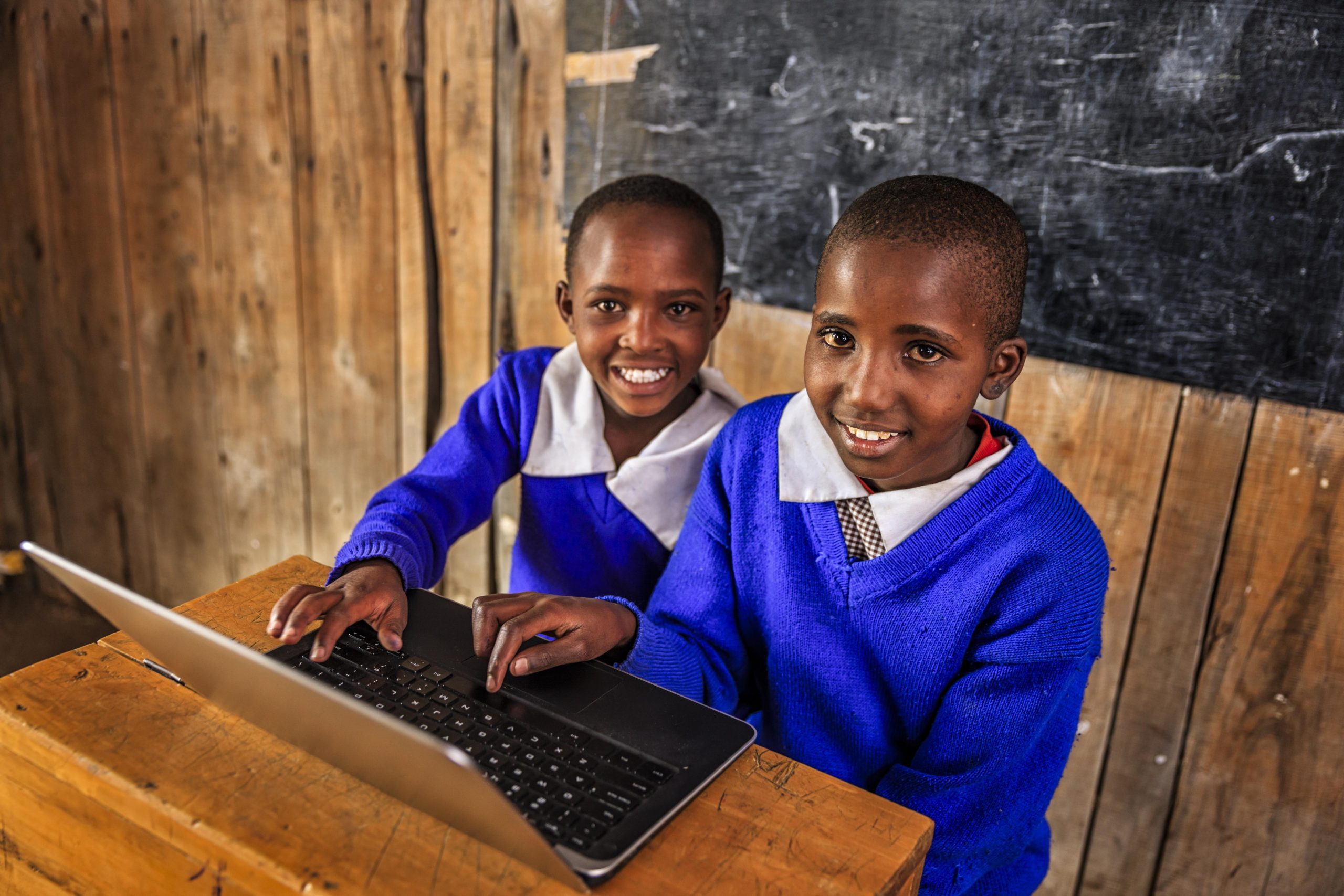African children using a laptop inside classroom in remote school in southern Kenya.