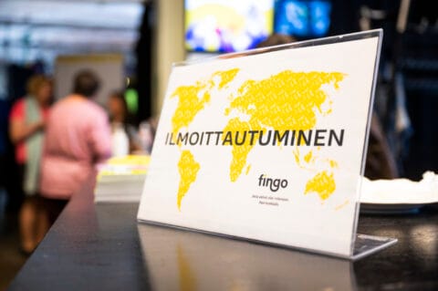 Vastaanottotiski, jossa kyltti Ilmoittautuminen.