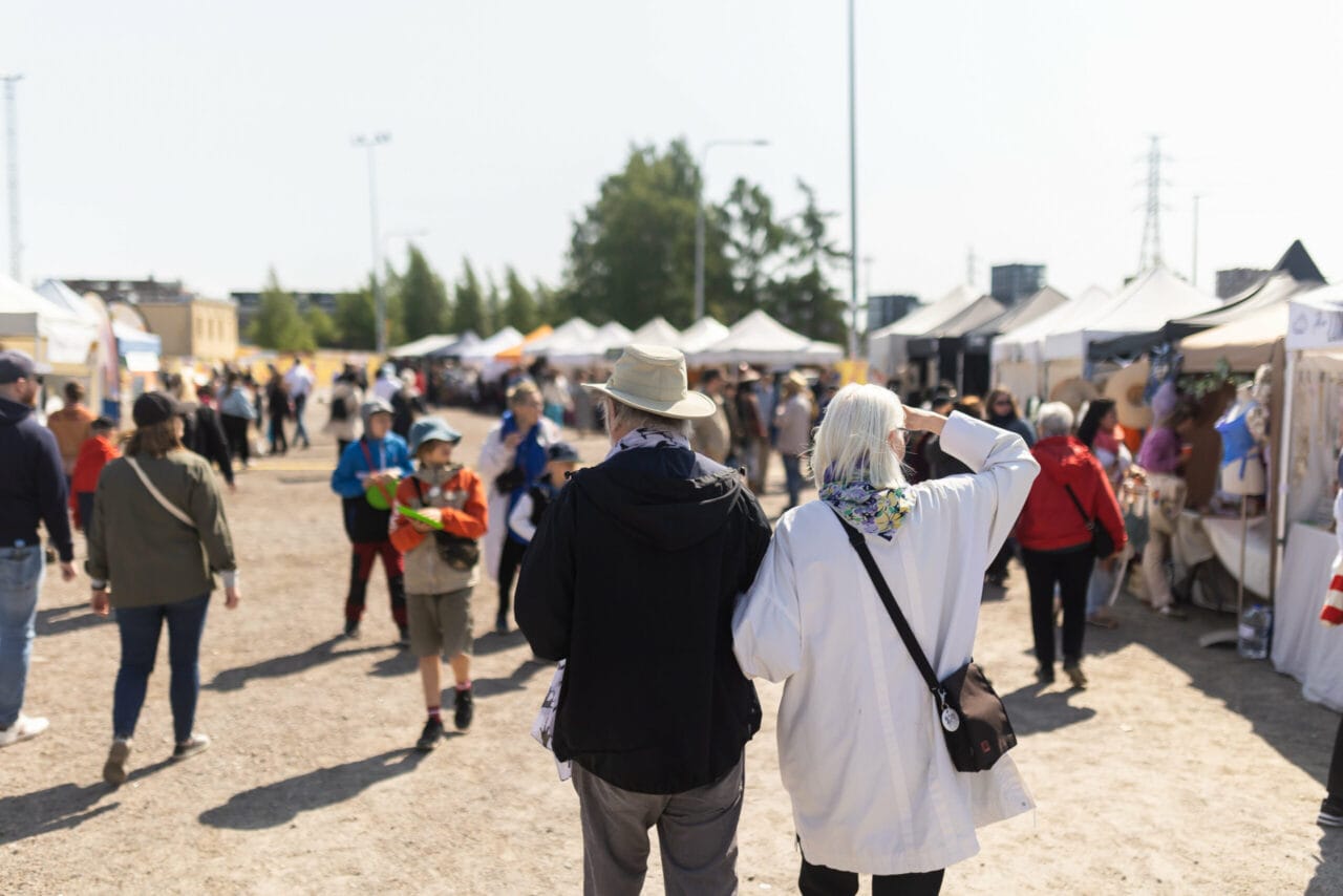 People in the festival area looking at the exhibitors' tents.